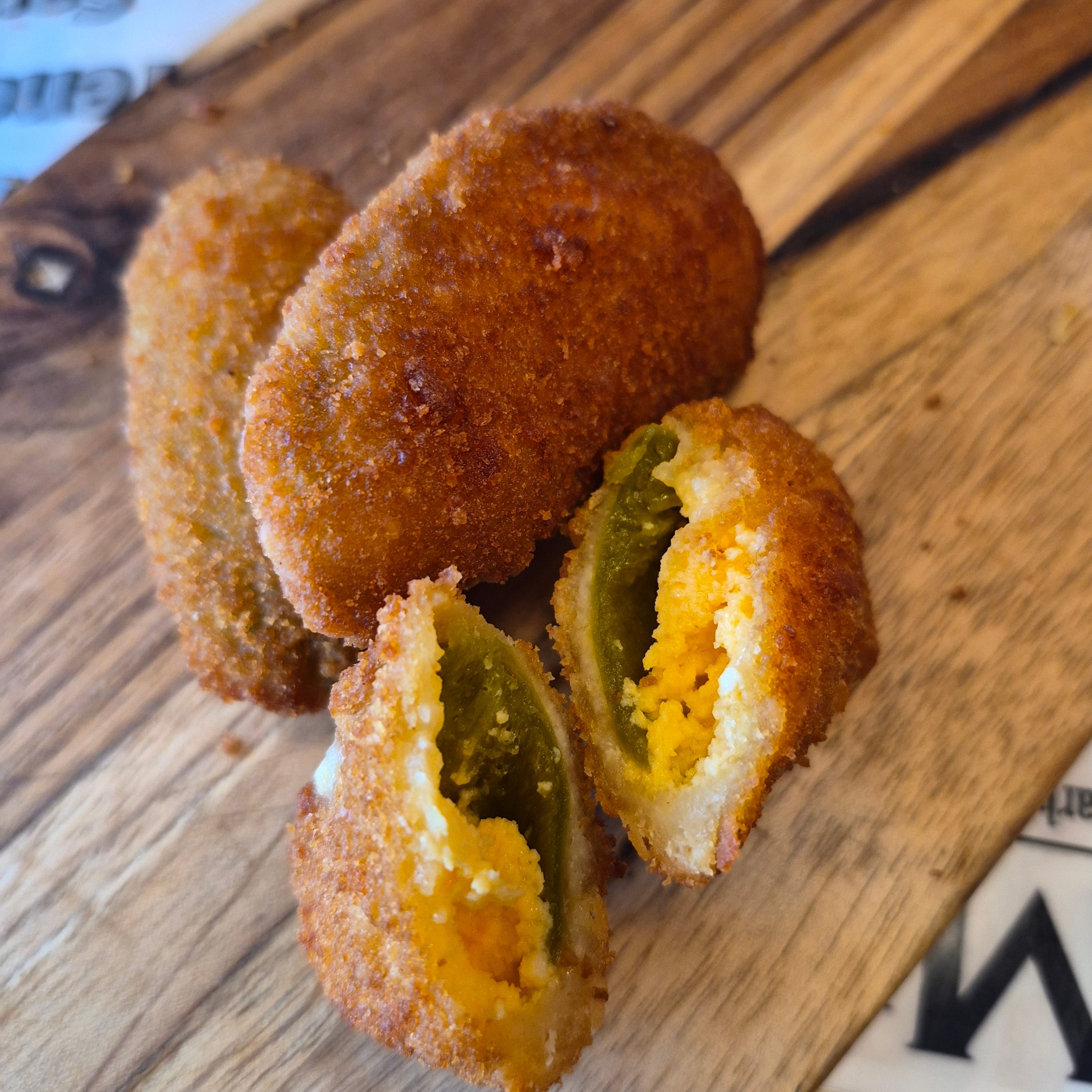 Cheddar-Stuffed Breaded Jalapeno Poppers.